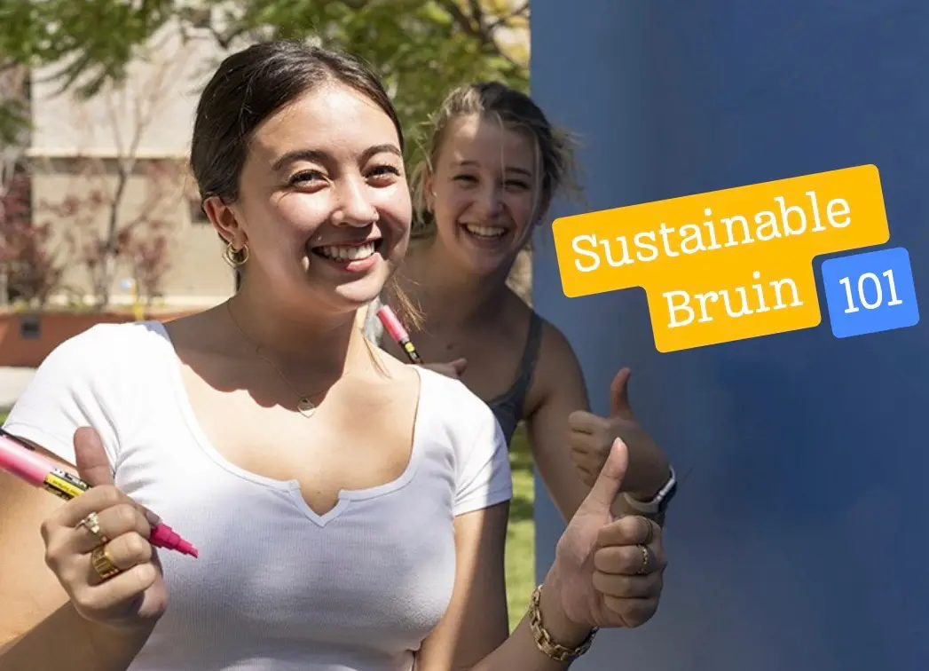 Two college-age female students in foreground and building and tree in background on left half of image, and text on right side of image "Sustainable Bruin 101"