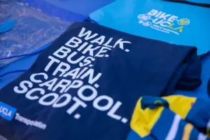 Dark blue shirt with words Walk.Bike.Bus.Train.Carpool.Scoot. and then UCLA Transportation